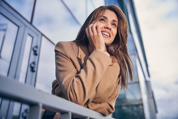 Portrait of a beautiful brunette female on the background of skyscrapers in the business district