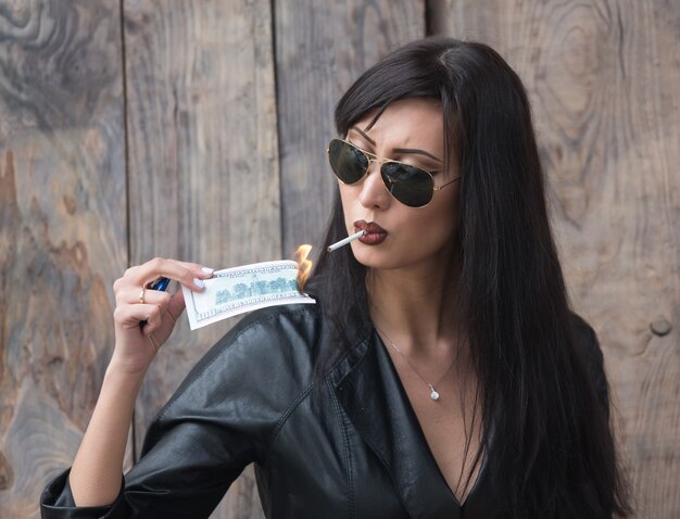 portrait of a beautiful brunette girl in a black leather jacket