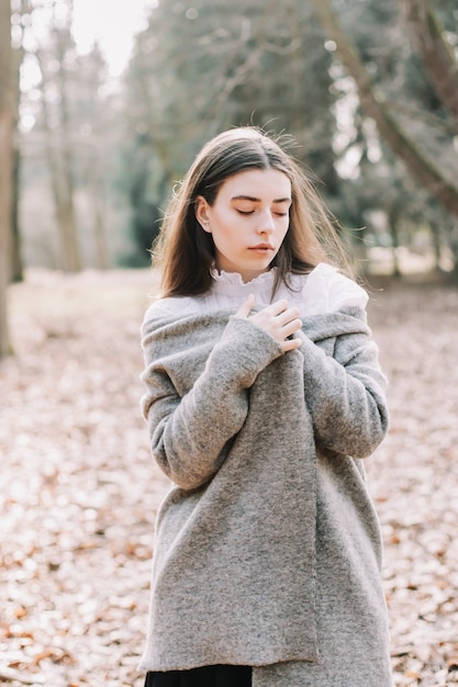 portrait of a beautiful brunette girl in the park