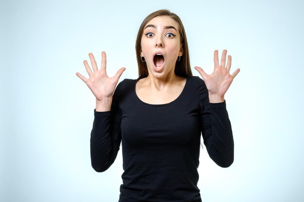 Portrait of a beautiful brunette girl with a surprised look