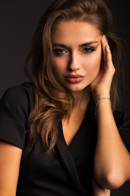 Portrait of a beautiful brunette. Luxurious woman with beautiful lips.