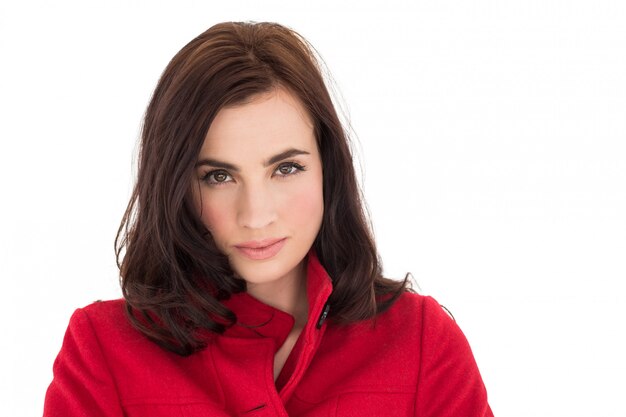 Portrait of a beautiful brunette in red coat