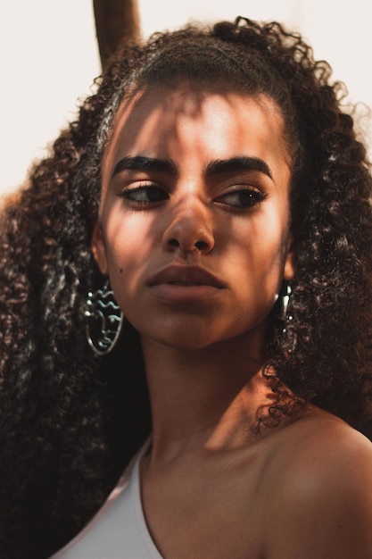 Portrait of a beautiful brunette woman with curly hair