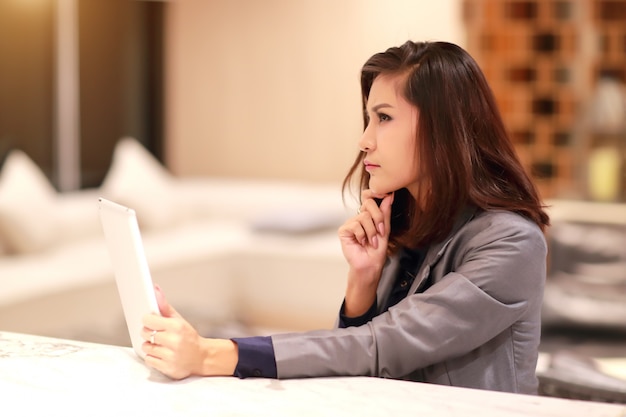 Portrait of beautiful businesswoman post using table and thinking 