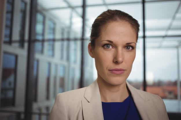 Portrait of beautiful businesswoman standing in corridor