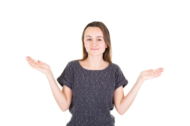 Portrait of beautiful calm young woman presenting by pointing showing both hand on side