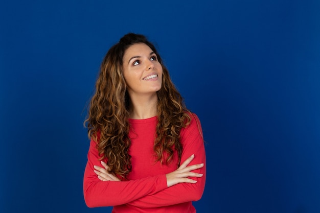 Portrait of beautiful caucasian girl with curly hair isolated on a white wall