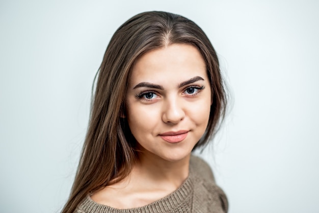 Portrait of beautiful caucasian young woman with perfect skin and makeup on white background.