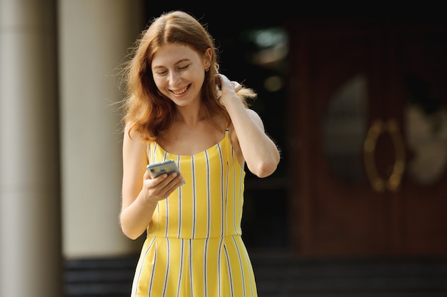 Portrait of beautiful cheerful redhead girl student.