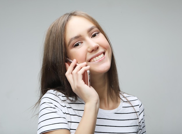 Portrait of beautiful cheerful woman talking on mobile phone