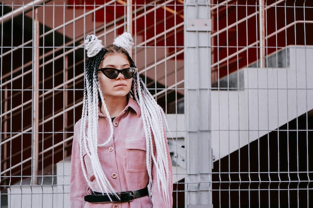 Portrait of beautiful cool girl over urban wall