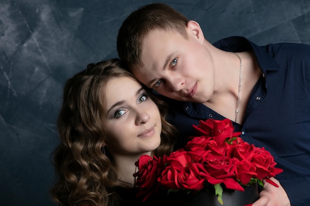 Portrait of a beautiful couple in love on a dark background