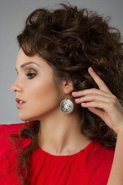 Portrait of beautiful curly woman in red dress