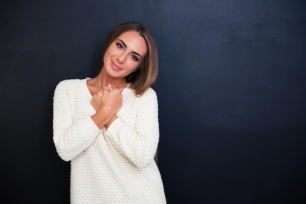 Portrait of a beautiful cute girl looking at camera over gray space