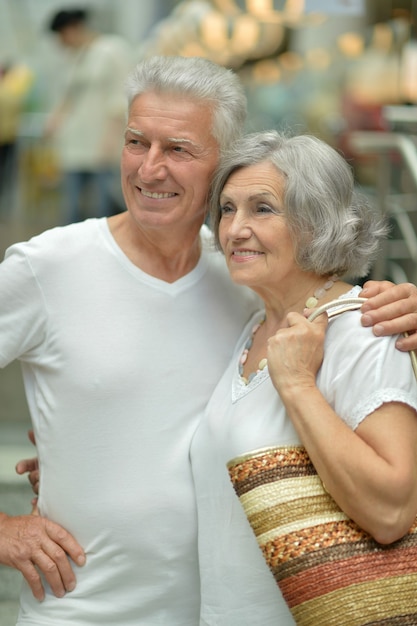 Portrait of beautiful elderly couple in shopping mall