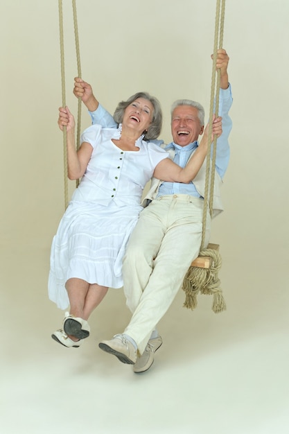 Portrait of beautiful elderly couple on swing