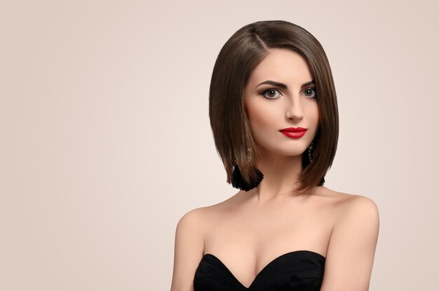 Portrait of beautiful elegant young woman posing in studio 