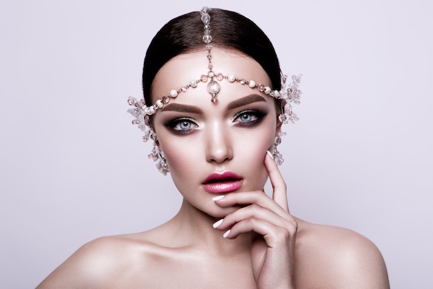 Portrait of a beautiful fashion brunette bride, sweet and sensual. Wedding make up and hair. Blue eyes.