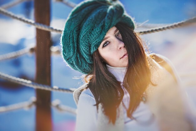 Portrait of a beautiful fashionable young woman in winter hat