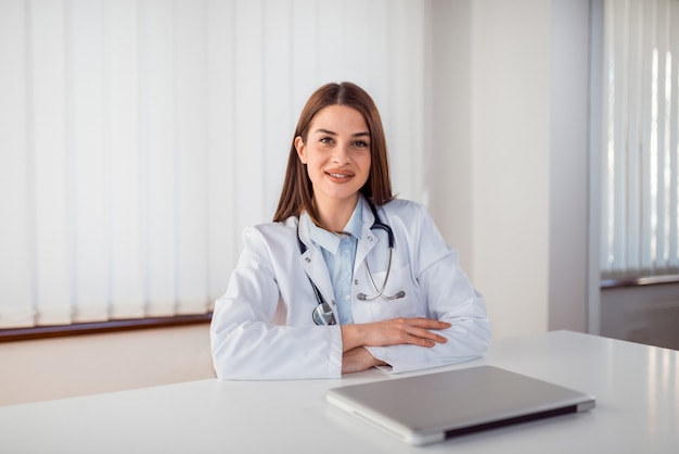 Portrait of a beautiful female general practitioner at medical office.