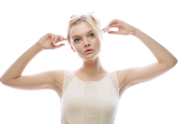 Portrait of a beautiful female model wearing white dress on white background