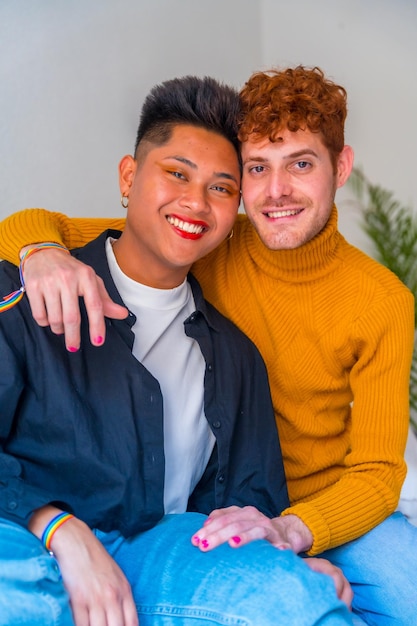 Photo portrait of beautiful gay couple wearing makeup and laughing smiling indoors at home lgbt concept