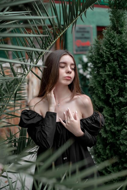 portrait of a beautiful girl on the background of a tree with flowers