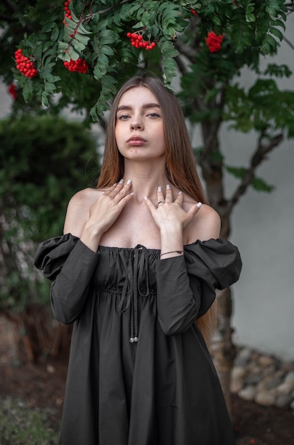 portrait of a beautiful girl on the background of a tree with flowers