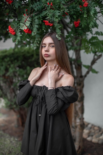 portrait of a beautiful girl on the background of a tree with flowers