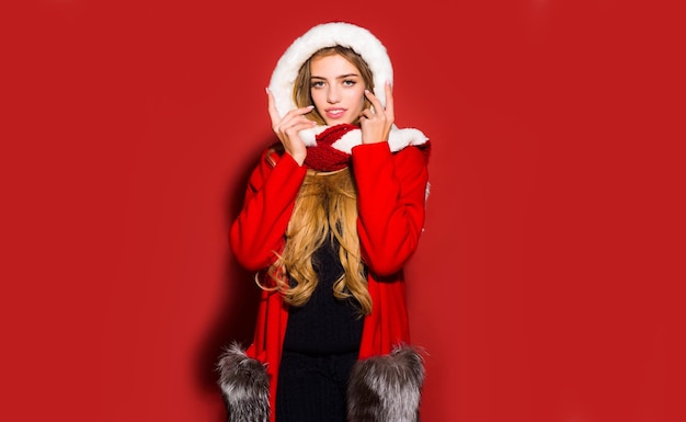 Portrait of a beautiful girl celebrate winter christmas holidays isolated on red background winter w