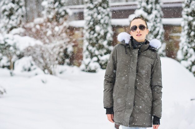 Portrait of beautiful girl in glases outdoor in snowy winter
