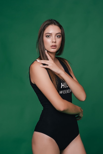 Portrait of a beautiful girl on green background.