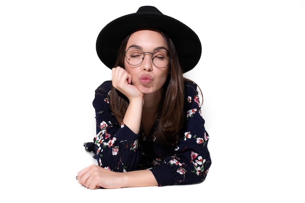 Portrait of a beautiful girl in a hat who poses for the camera with emotions