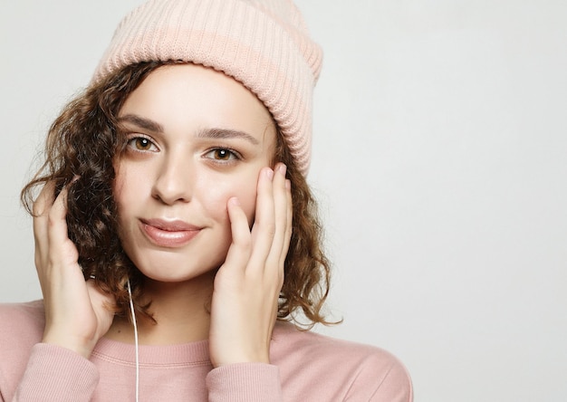 Portrait of a beautiful girl in headphones listens to music and