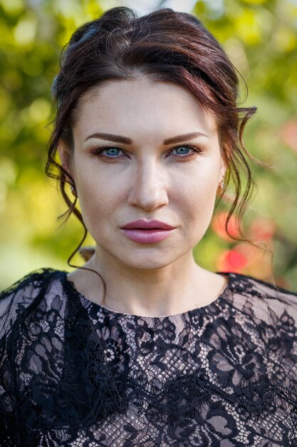 Portrait of a beautiful girl in a lace dress in a park