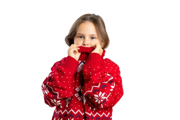 Portrait of beautiful girl in oversize red knitted christmas sweater with reindeer touching high col...