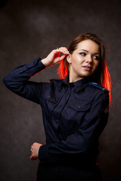 Portrait of a beautiful girl in police uniform. Professional posing