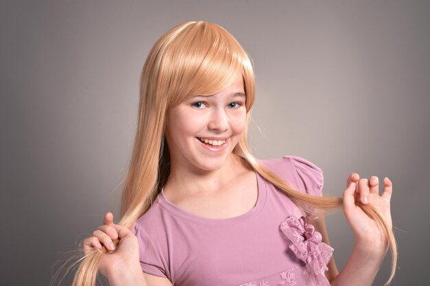 Portrait of beautiful girl posing in studio on background