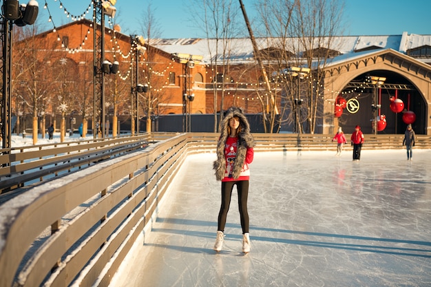 Portrait of a beautiful girl at the rink in winter