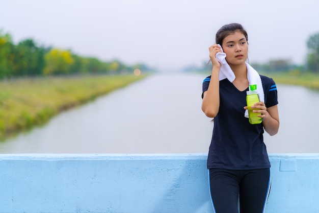 Portrait of a beautiful girl in sportswear with a bottle of water