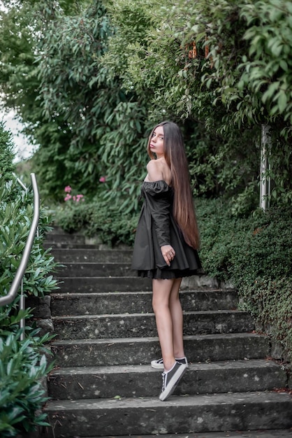 portrait of a beautiful girl on the stairs in the park