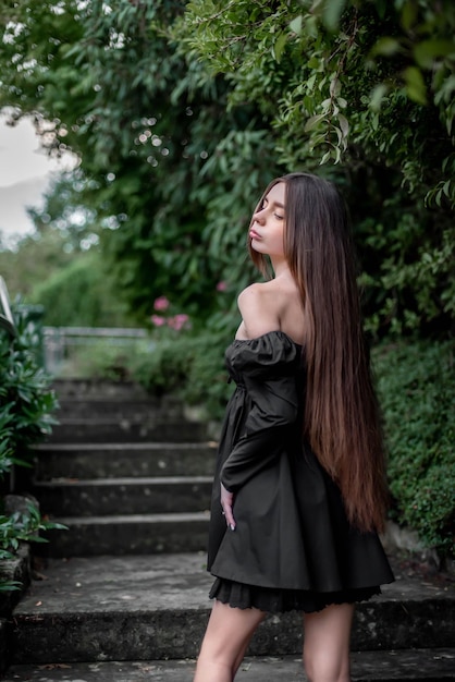 portrait of a beautiful girl on the stairs in the park