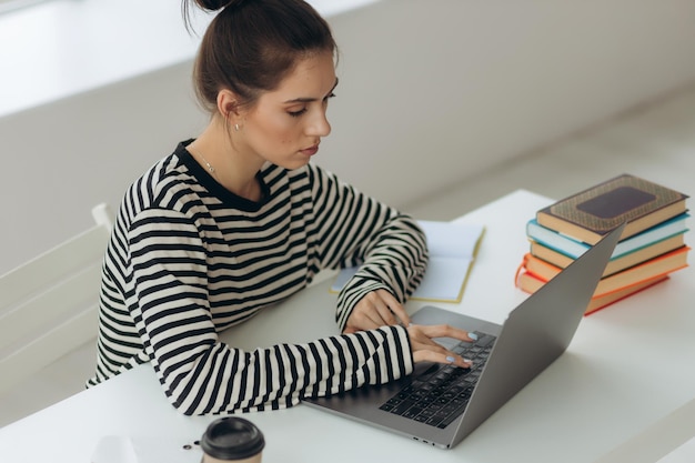 Portrait of a beautiful girl studying at home