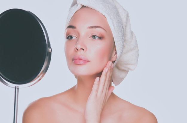 Portrait of beautiful girl touching her face with a towel on head