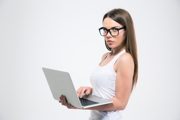 Portrait of a beautiful girl using laptop isolated