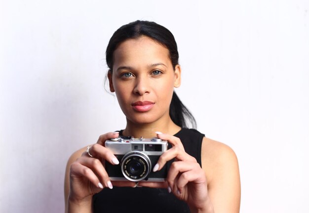 Photo portrait of a beautiful girl using a video camera