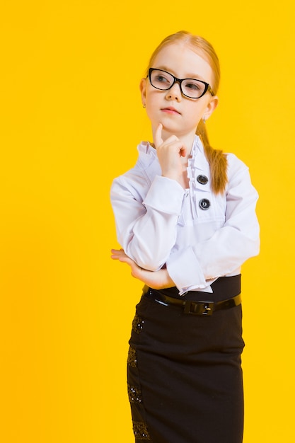 Portrait of a beautiful girl in a white blouse and black skirt.