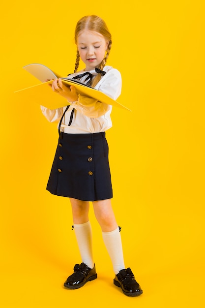 Portrait of a beautiful girl in a white blouse and black skirt.