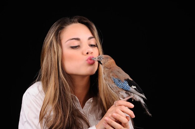 Portrait of beautiful girl with bird on the hand