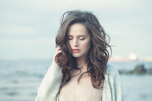 Portrait of a Beautiful Girl with Curly Hair on a Cold Windy Day Outdoors